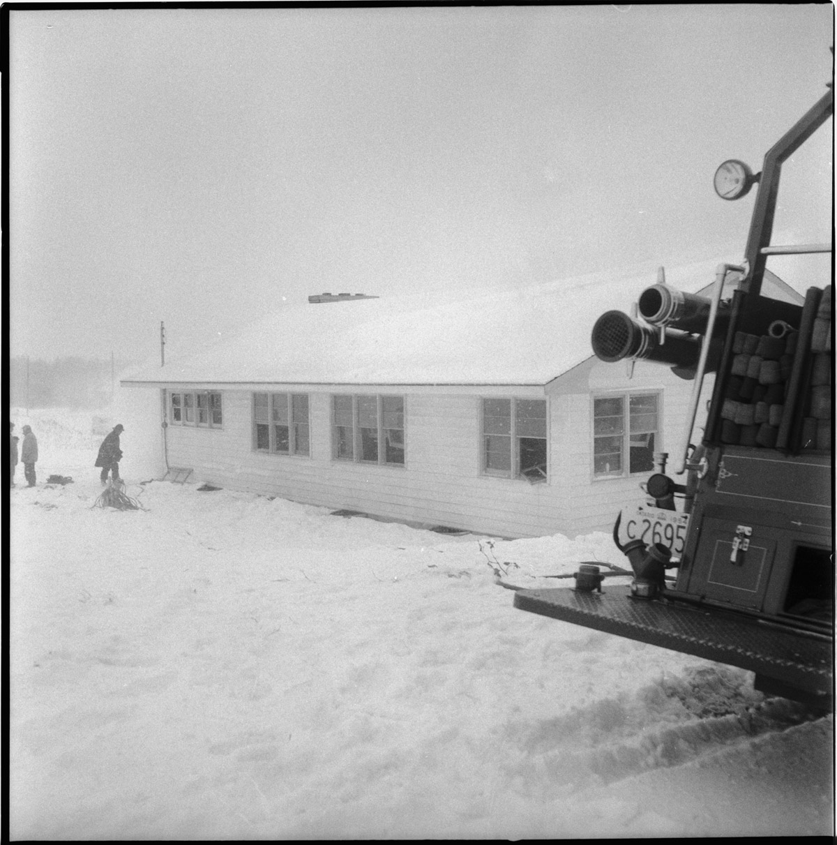 Thames Valley Club House covered in snow with firetruck in the fore ground