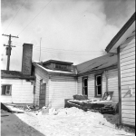 Outside of the burned building showing damage to the roof.