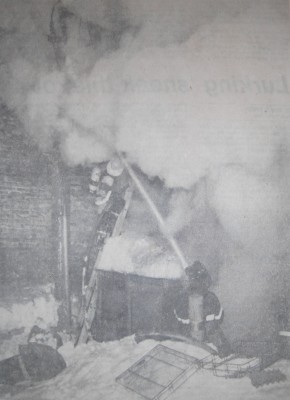 Smoke pours from the rear of the Tamblyn store