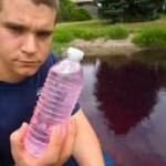 20120526-164107.jpg Student holding bottle of colured water from pond