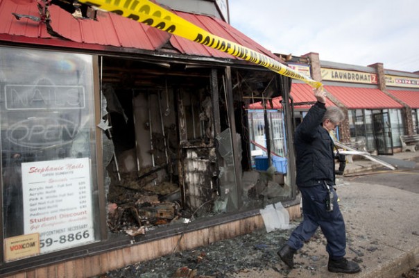 An investigator from the Ontario FIre Marshall's office surveys fire damage at Blue Lagoon II on Oxford Street East in London on Sunday January 8th, 2012. (CRAIG GLOVER, The London Free Press)