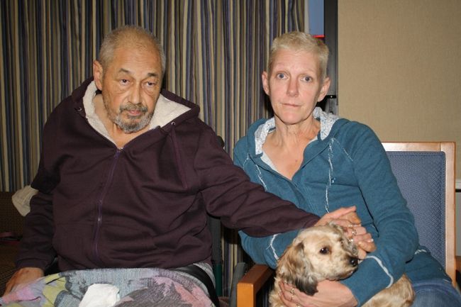  Leo Bouillon and his wife Susan Bouillon comfort each other and their dog Belle in a hotel room after a fire in their apartment unit left them homeless. Neighbours carried Leo, a double amputee, down six flights of stairs of the apartment building where the couple lived at 1132 Adelaide St. N. (Andrew Forbes, Special to The Free Press)