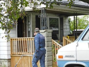 A police investigator at the scene of a house fire that left one person dead on Manitoba Street early Monday morning (Sept. 16).