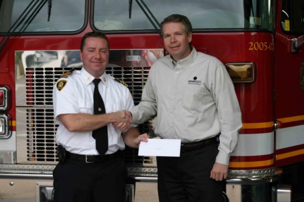 Deputy Chief Jim Jessop accepts donation from Ian Ross of Union Gas. (Photo courtesy of the City of London Fire Department)