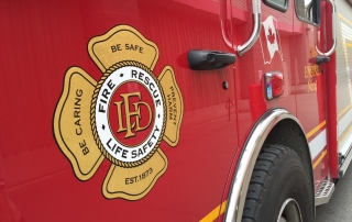 Stock photo of the door of a firetruck displaying the LFD crest