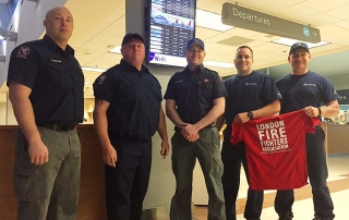 Five London Fire fighters pose as they are getting ready to fly out to Alberta