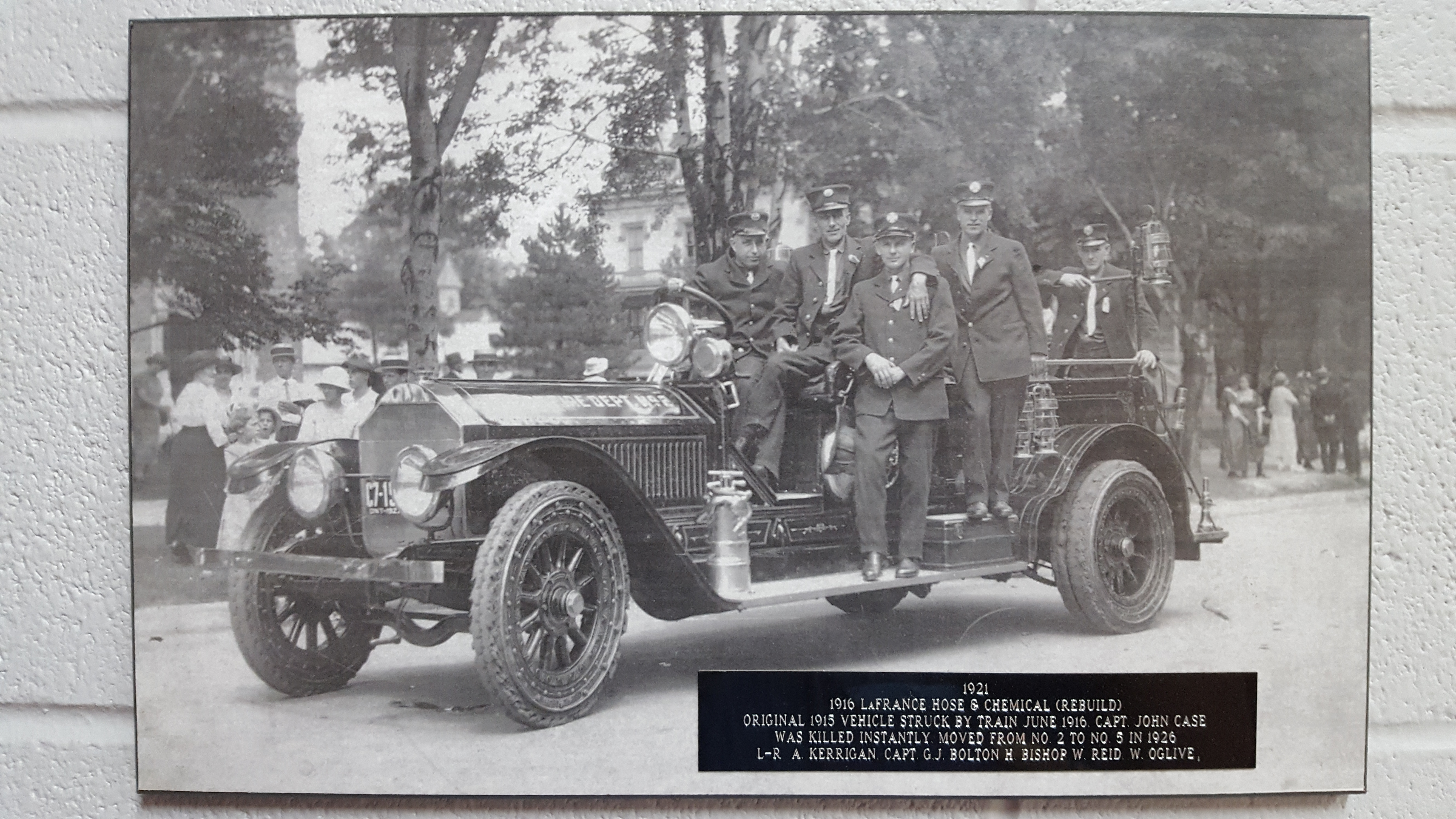 1916 LaFrance Hose & Chemical (Rebuild). Original 1915 vehicle was struck by a train June 1916. Capt. John Case was killed instantly. This vehicle was re-positioned from Station 2 to Station 5 in 1926. L-R: Capt. G.J. Bolton, H.  Bishop, W. Reid, W. Oglive.  Circa 1921.