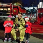 Firefighter sitting with daughters