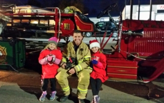 Firefighter sitting with daughters