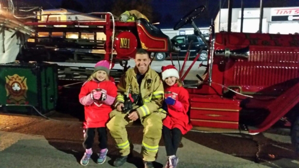 Firefighter sitting with daughters