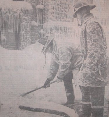 Firefighters chopping hoses out of ice.