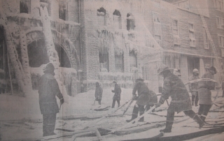 Firefighters pulling frozen lines from the ice that formed during the fire at the YM-YWCA fire.