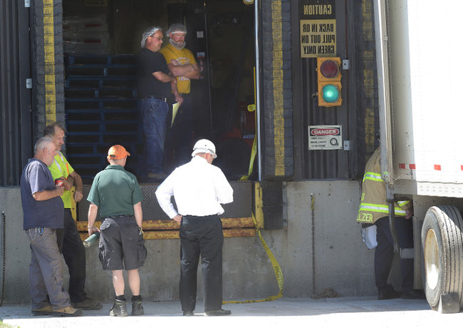 Workers looking at te accident scene around a loading dock