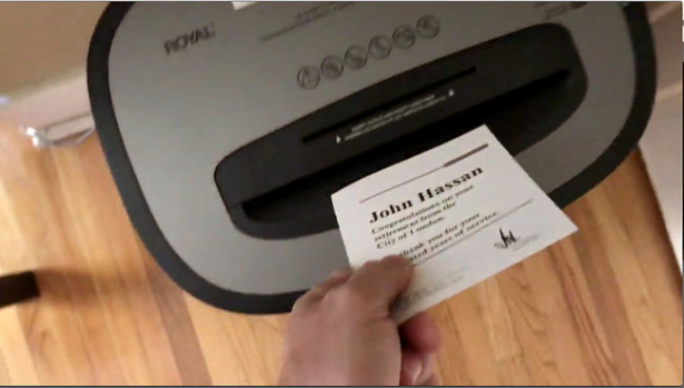 A video shows John Hassan shredding his congratulation note from the city on his retirement.