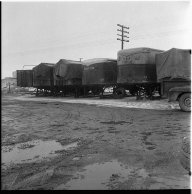 Line of transport trailers withe their covering tarps burned.