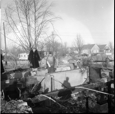 Family surveys the damage from the fire that ravaged their home.