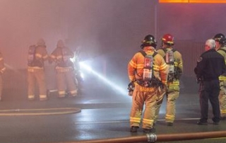 London Fire fighters in the smoke from a house fire