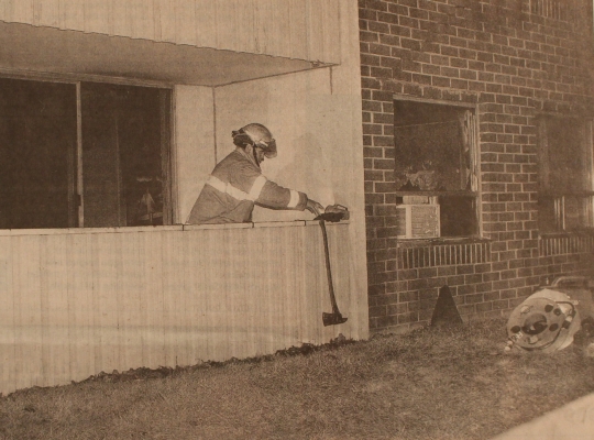 Fire Fighter Fred Radley prepares to leave the balcony of a fire-damaged apartment at 261 Platt's Lave after a blaze last night in which am elderly woman was killed.