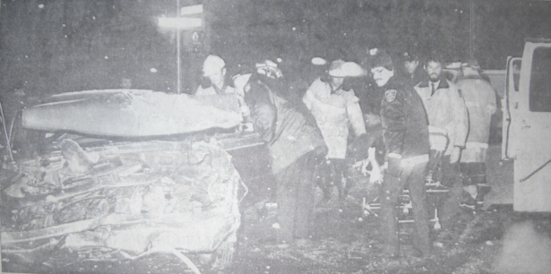 Fire, EMS and Police personnel working to free trapped persons from wreckage.