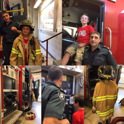 Fire fighters show children the fire truck and equipment.