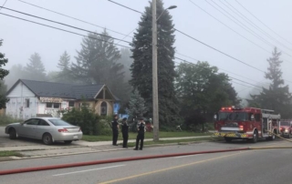 Police look on during house fire