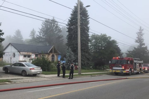 Police look on during house fire