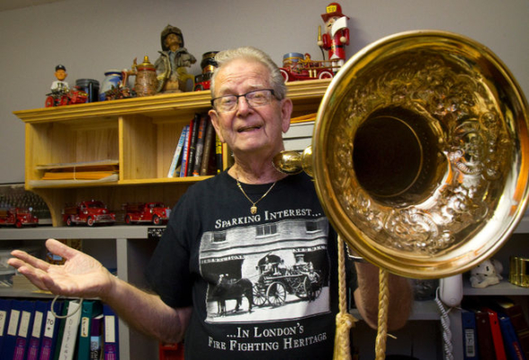 Fire Chief Jim Fitzgerald (retired) holding a trumpet used in 1800's at fire scenes