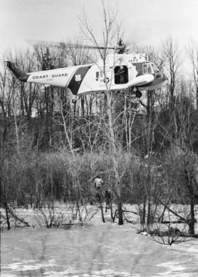 US helicopter hovering and lifting trapped victims to safety.