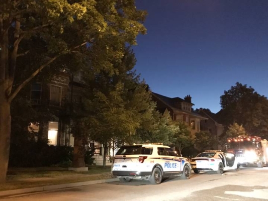 Police cars parked in front of house fire