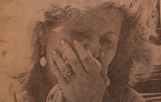 Woman sobbing into her hand