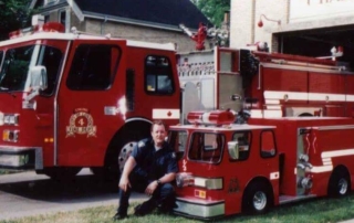 Firefighter Tim Knight posing with Engine
