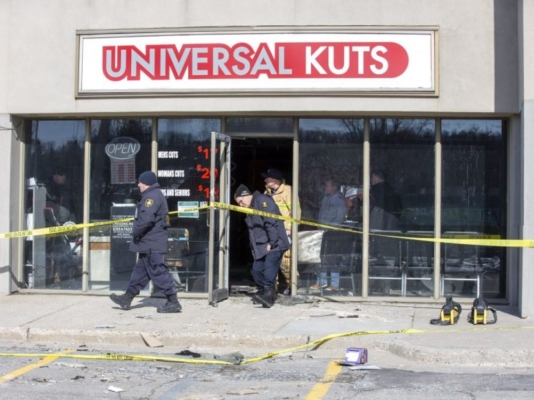 Fire investigators and firefighters walking out of barber shop