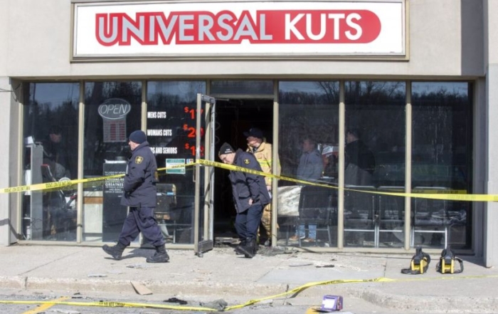 Fire investigators and firefighters walking out of barber shop