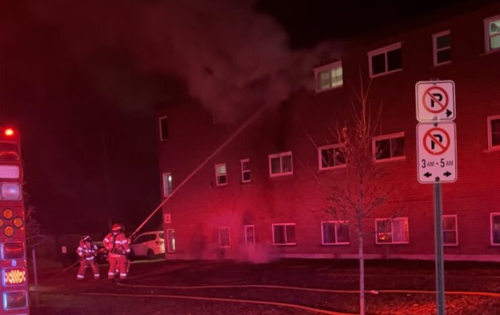 Fire fighters applying water into a third floor window. (Source: Twitter - @LndOntFire)