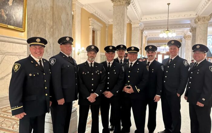 Fire fighters posing after receiving medal of bravery at Queens Park.