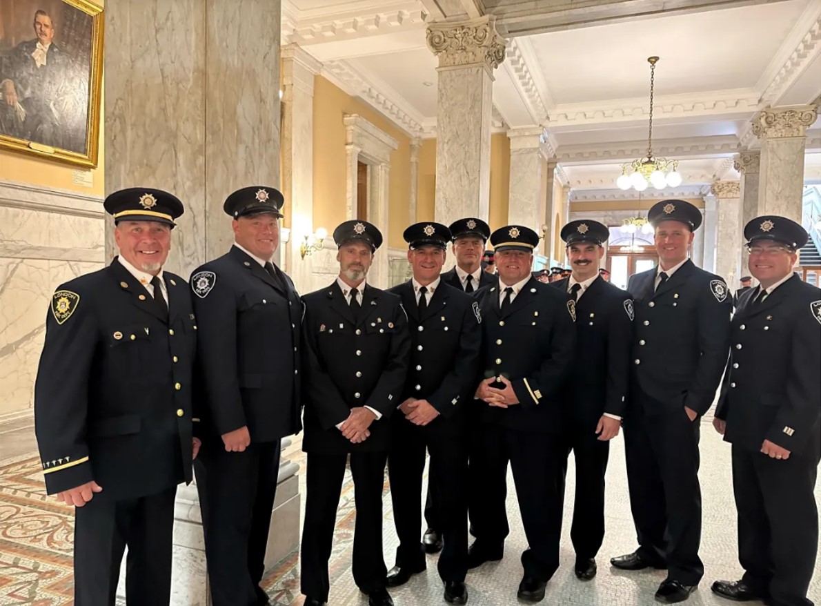 Fire fighters posing after receiving medal of bravery at Queens Park.