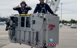 Firefighter with city councilor in platform truck, TRex