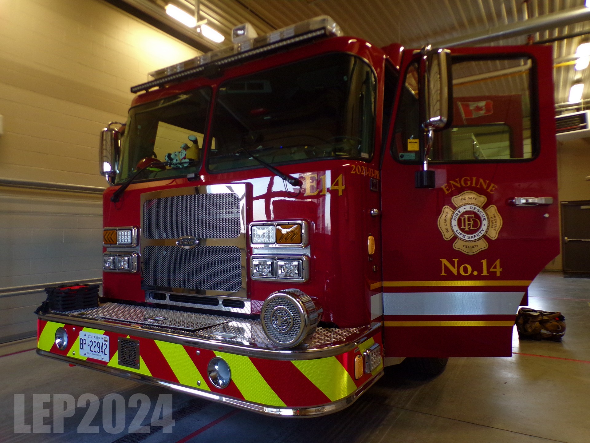 Engine parked inside station 14 with the driver's door open so you can see the logo and engine number