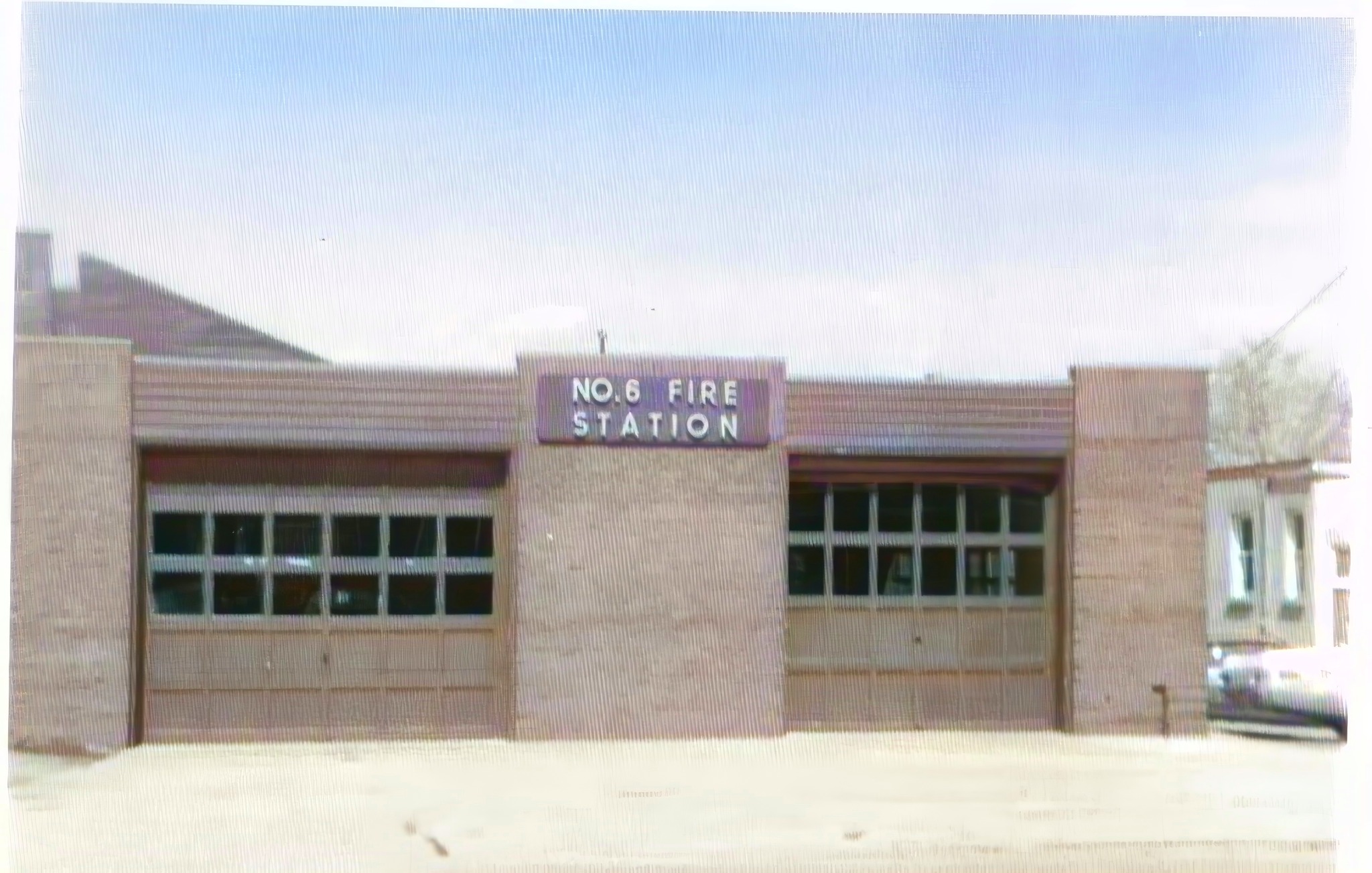 The front of fire station 6 in Byron, Ontario. Two large bay doors with a sign between them stating No. 6 Fire Station.