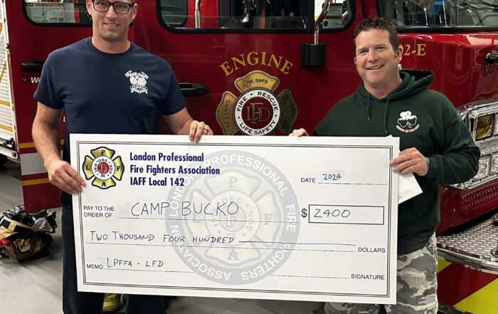 FF Sean Foxton presenting a cheque to Camp BUCKO representative.