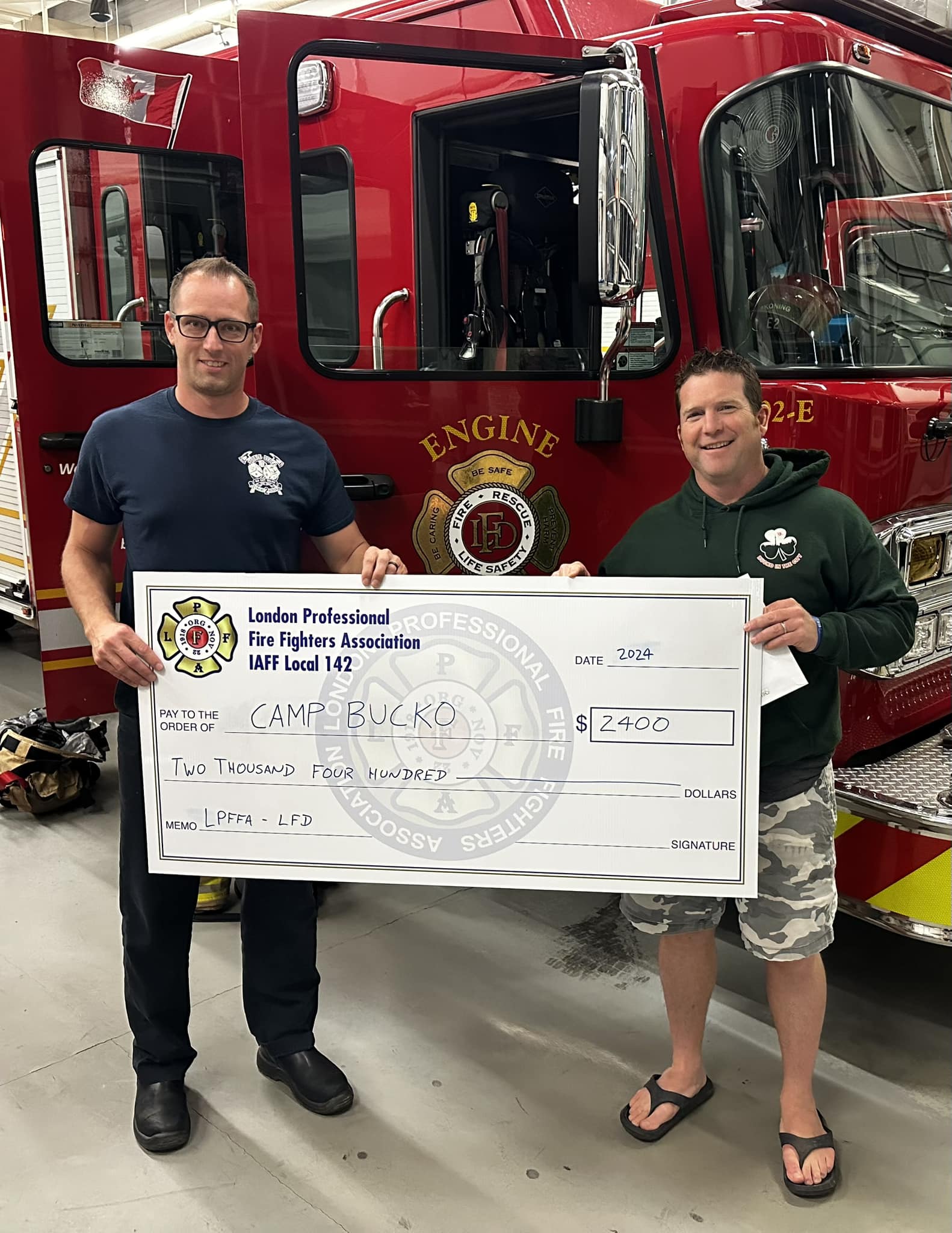 FF Sean Foxton presenting a cheque to Camp BUCKO representative.