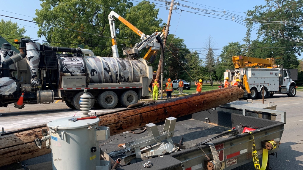 Hydro crews using a bucket truck repairing a heavily damaged pole after a car crash the night before