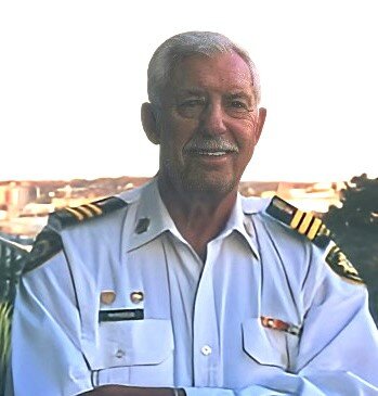 Captain Paul McPherson in uniform smiling at the camera