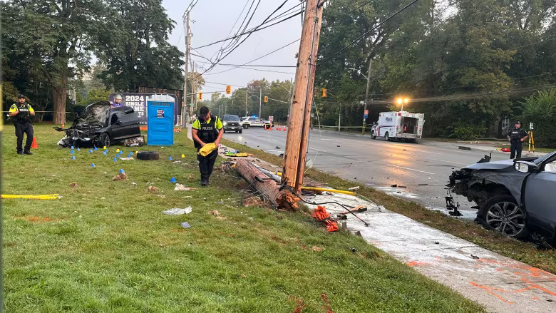 Daylight image of two vehicle collision and hydro pole damage