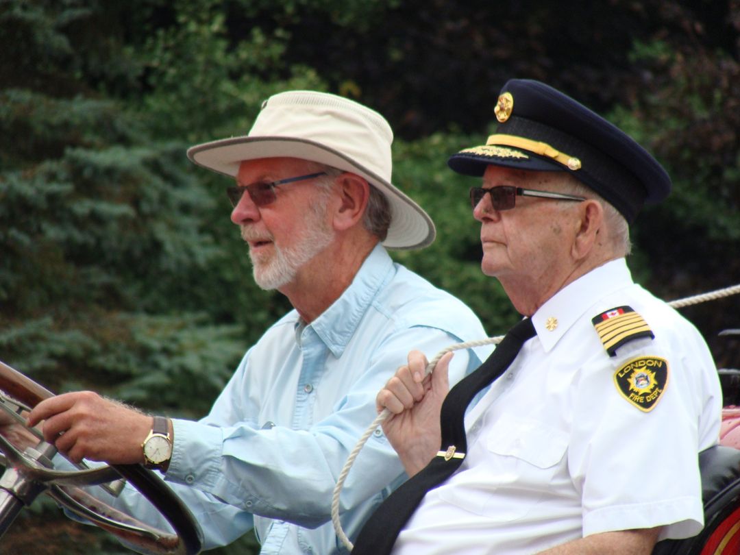 Chief Jim Fitzgerald riding on an antique fire truck at the St. Thomas Fire Muster 2015.