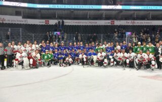 London Police and Fire personnel posing after a charity hockey game.