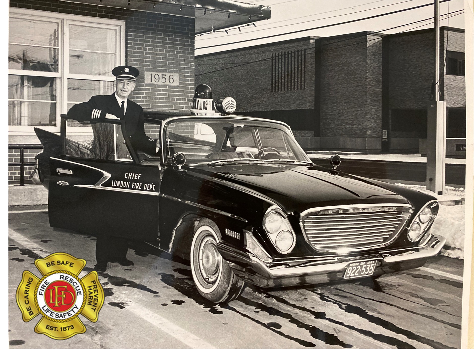 Fire Chief Mathers posing with his 1961 Chrysler Windsor in front of Station 1