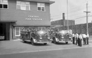 London Fire fighters standing around two new fire engines at Headquarters on Waterloo Street