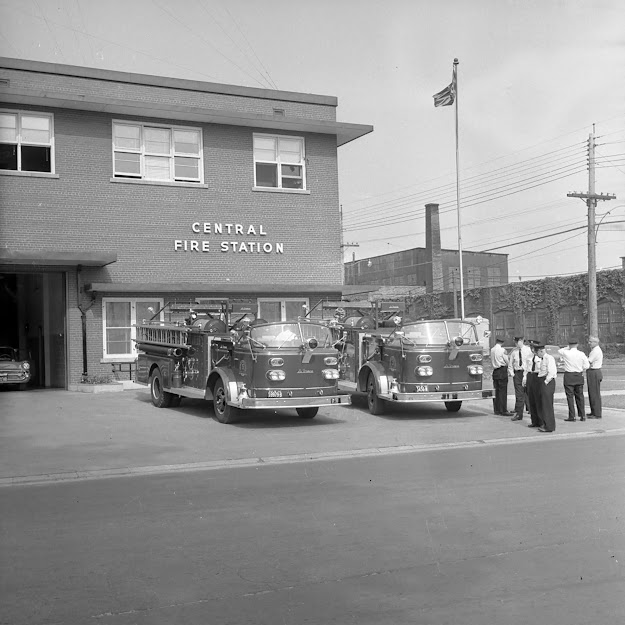 London Fire fighters standing around two new fire engines at Headquarters on Waterloo Street