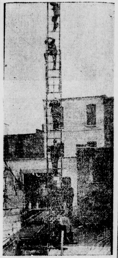 Several London Firemen practising on climbing the 65' ladder